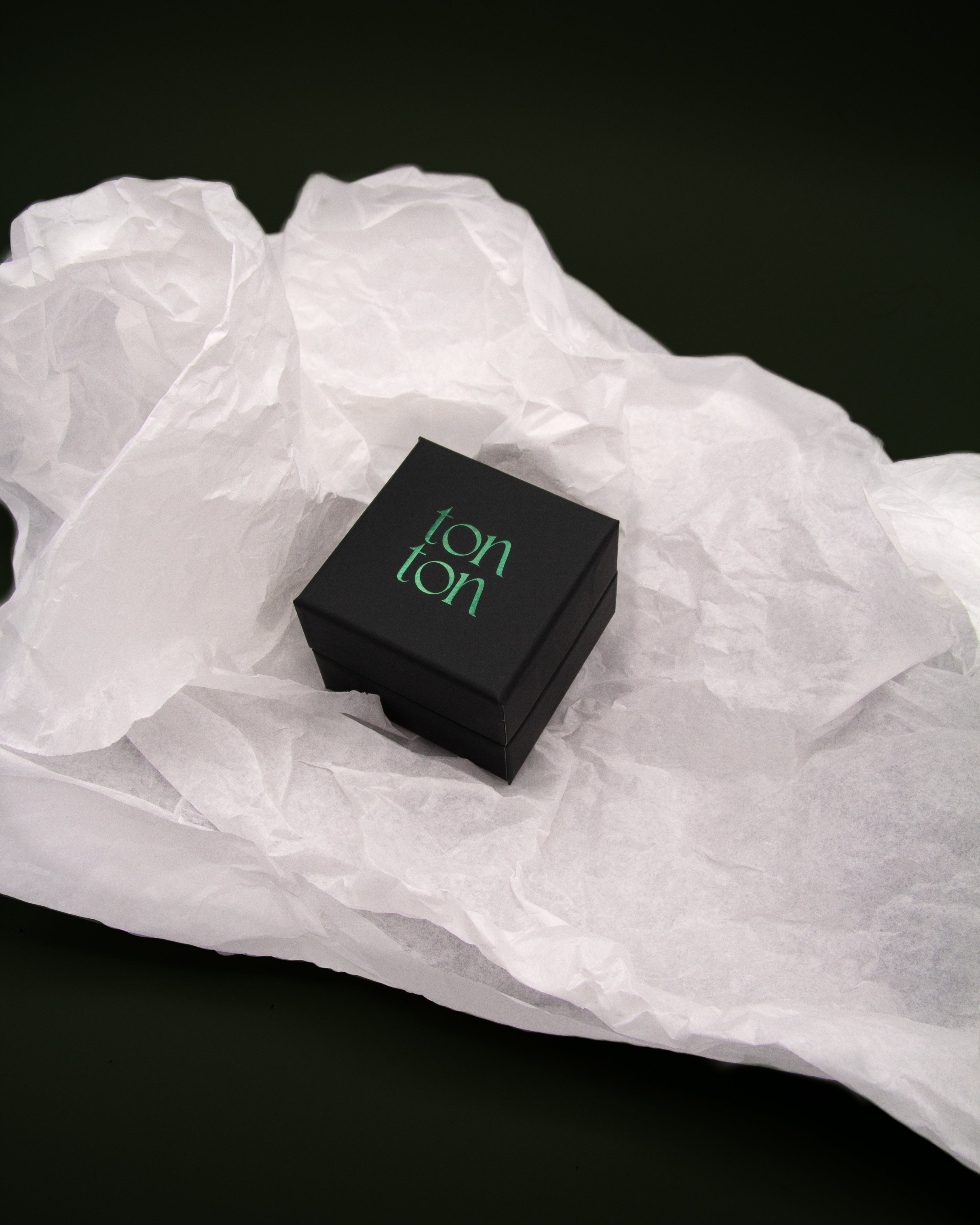 Our signature Ton Ton jewelry box in dark green, designed for elegant presentation and included with the earrings.