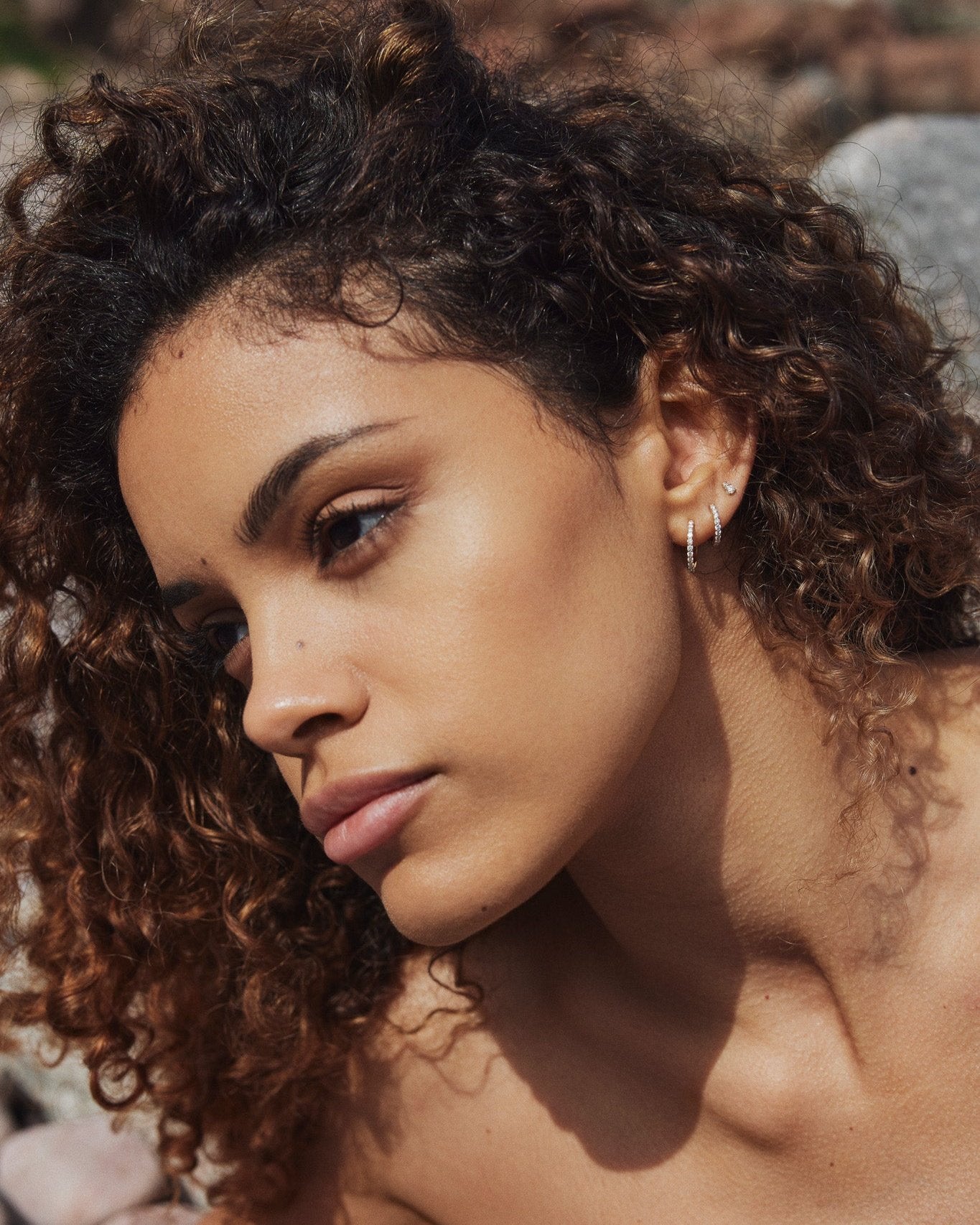 Medium Diamond Hoop earring in recycled 14K white gold with 11 lab-grown diamonds, shown stacked with the Diamond Duo Stud.